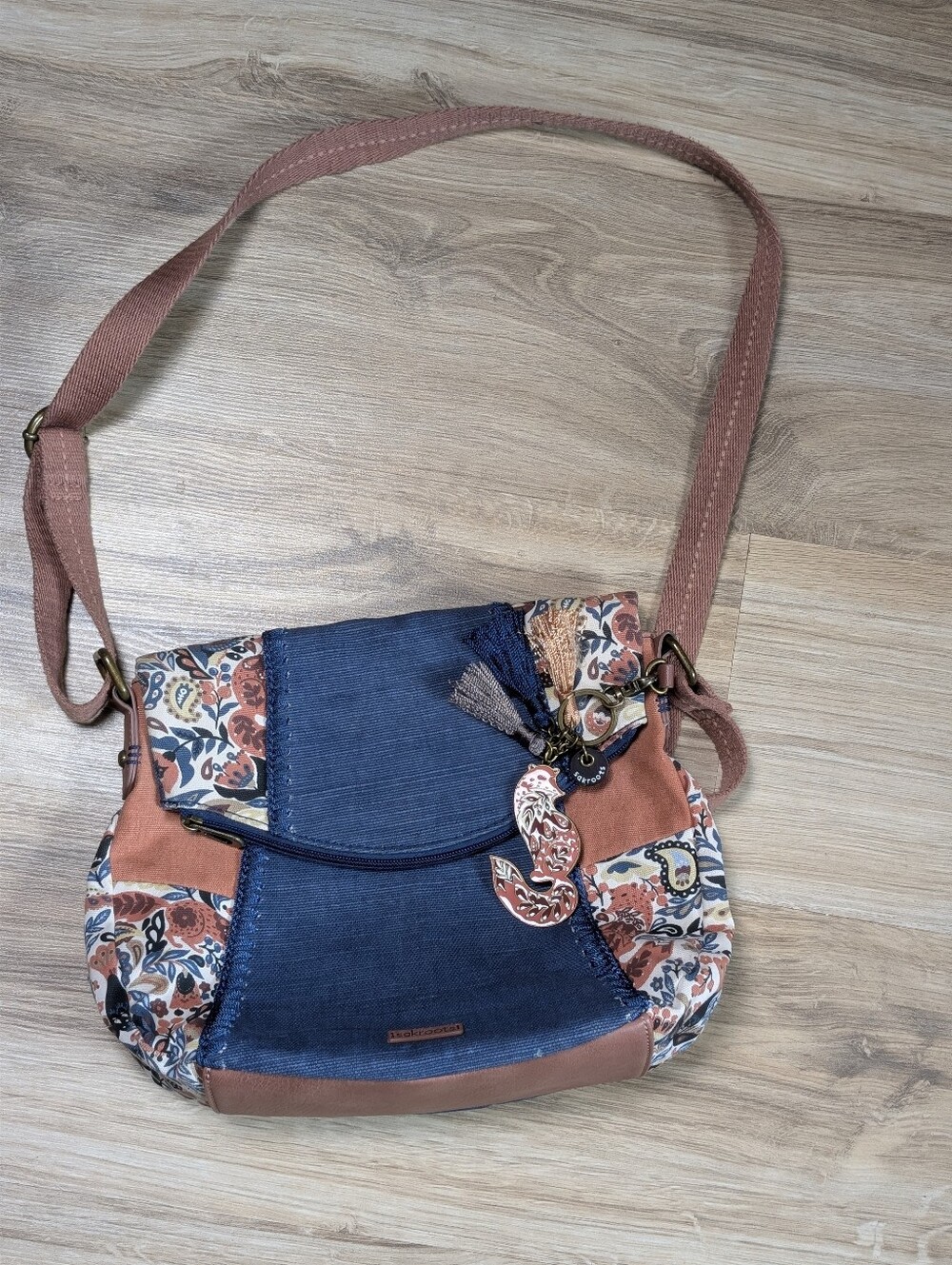 Sakroots Women's Flower Power Crossbody is a medium-sized